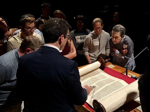 Group of converts gathered around Torah